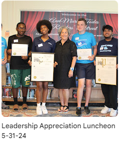 School leaders standing with district official