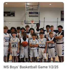 middle school basketball athletes posing for a photo in gym