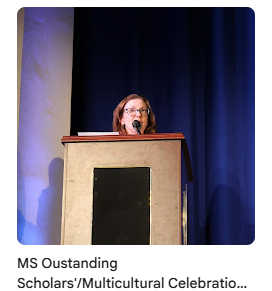 principal Smyth giving speech on stage during assembly