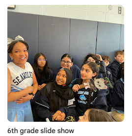 students sitting on gymnasium bleachers