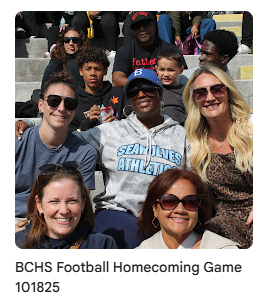 scholars academy faculty on bleachers during homecoming game