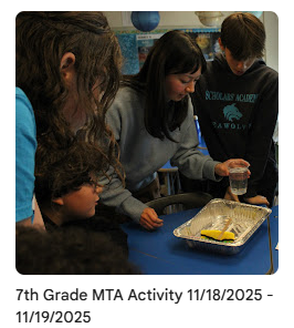 Students gathered around table during project