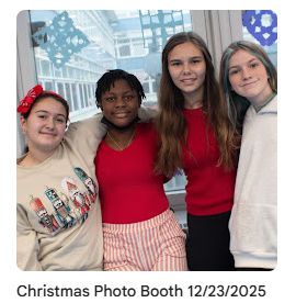 Students taking group photo together in front of winter decorations
