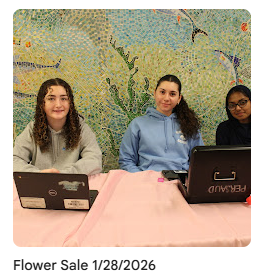 Key Club members set up at table outside mosaic