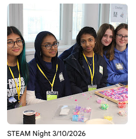 Members of fashion club behind table with bracelet-making activity